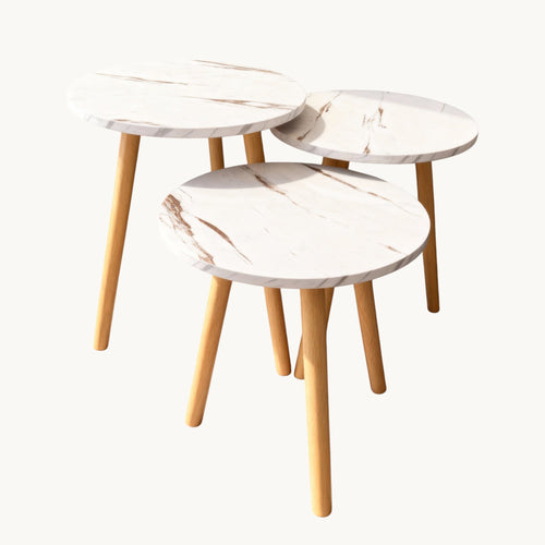 Trendy Shop 3-piece nesting table set with white marble-look round tops and natural wood legs. Use together or separately.